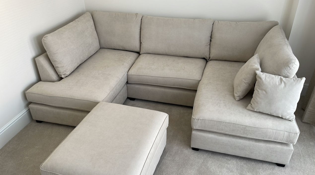 Carnabie U Shaped Fabric Corner Sofa with footstool in a modern living room setting.