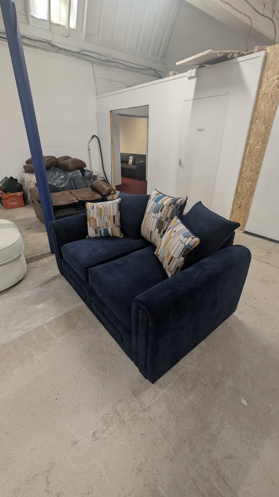 Navy blue Lounger Fabric Sofa 2 seater with patterned cushions.