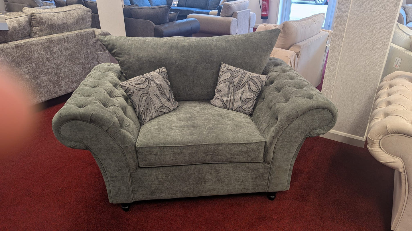 Windsor Chesterfield Cuddle Chair in grey, plush tufted design with patterned cushions, available in cream or grey.