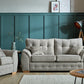 Ashley Fabric Sofa Collection with cushioned armrests and buttoned back cushions in a modern living room setting.