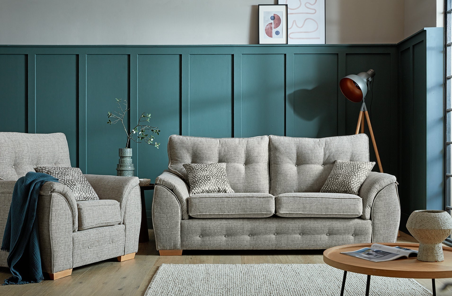 Ashley Fabric Sofa Collection with cushioned armrests and buttoned back cushions in a modern living room setting.