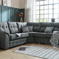 Ashley Fabric Sofa Collection in modern living room with buttoned back cushions and cushioned arm rests.