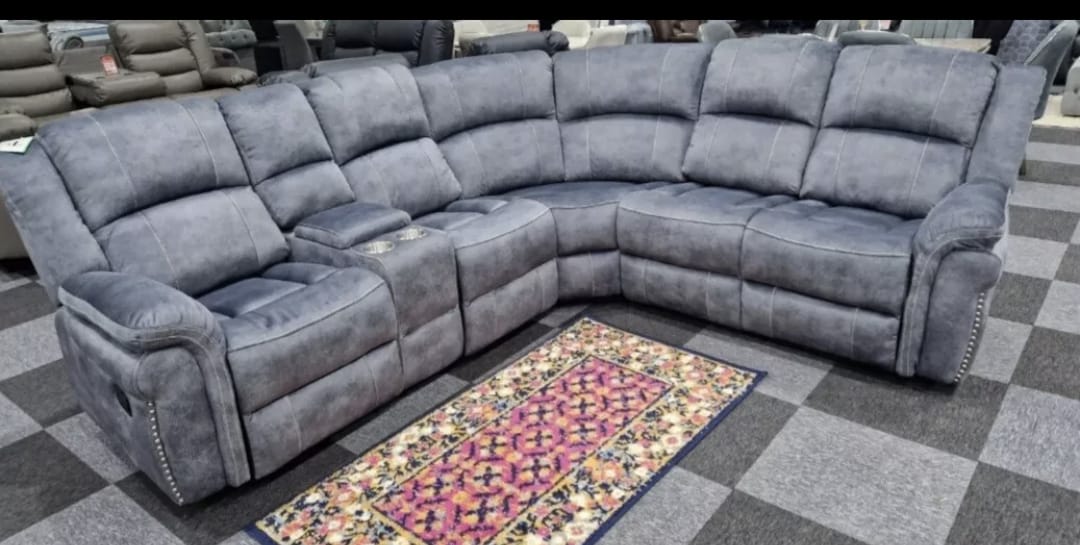 Brentwood Fabric Corner Sofa Recliner in grey with console on display.