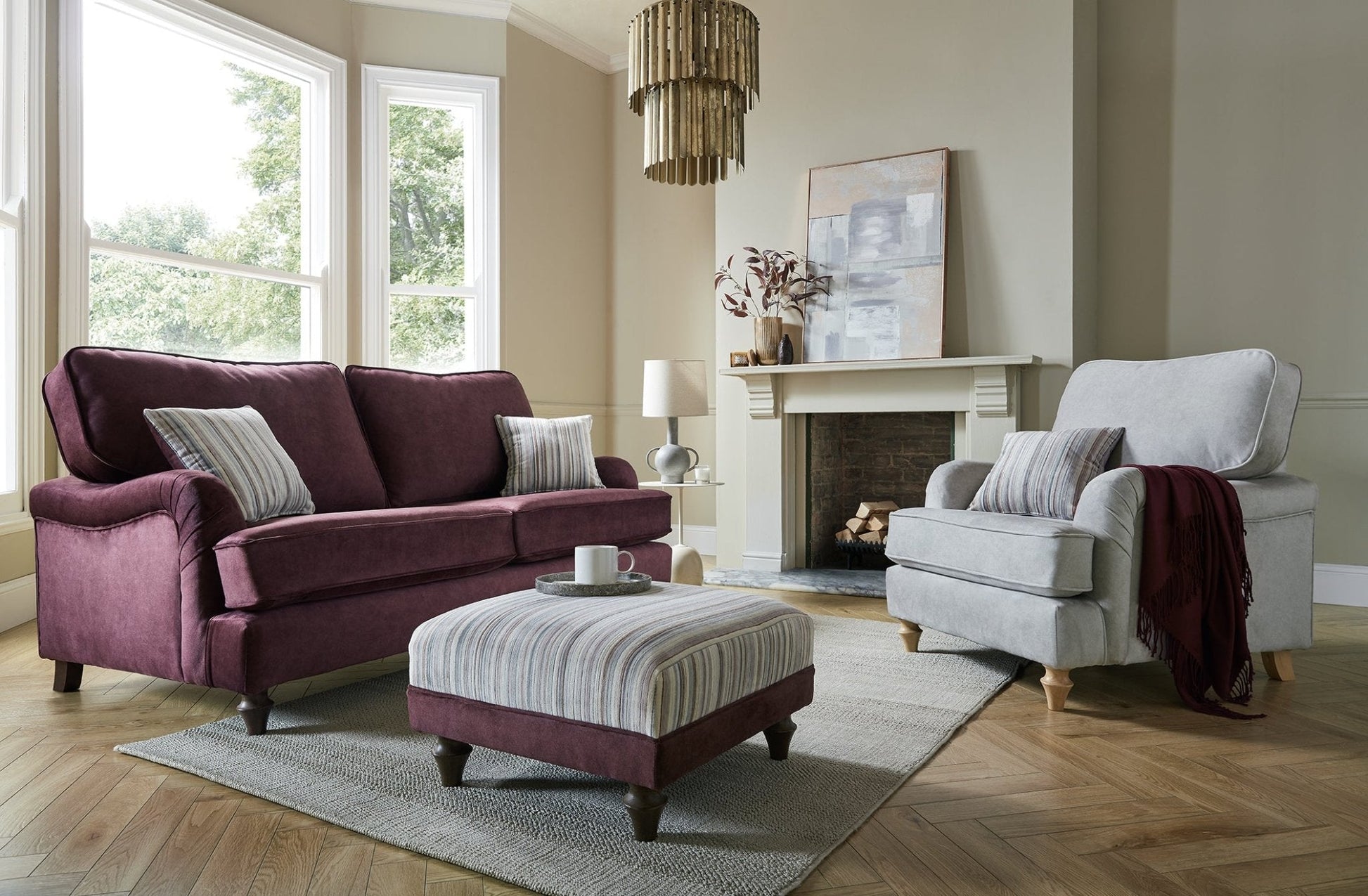 Canterbury Fabric Sofa Collection in a stylish living room setting with footstool and chairs.