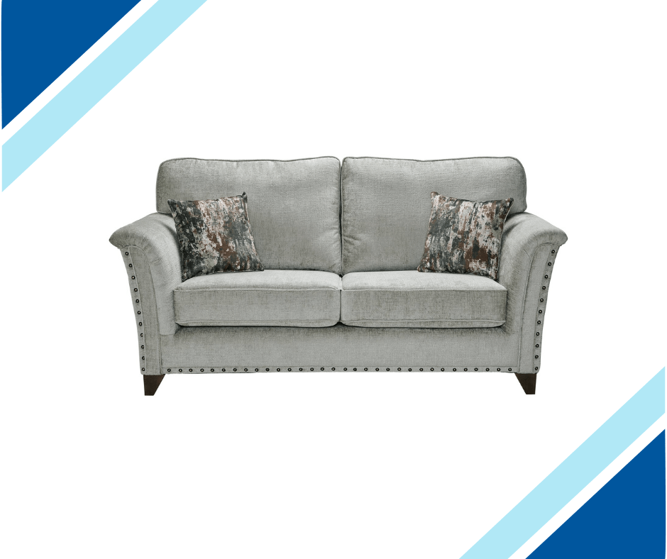 Carrington Fabric Sofa Collection with hand-studded arms, shown in grey with decorative pillows.