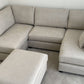 Carnabie U Shaped Fabric Corner Sofa with footstool in a modern living room setting.
