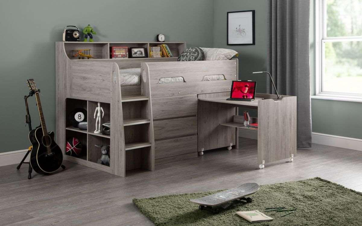 Jupiter Wooden Mid Sleeper in grey oak finish with pull-out desk, drawers, and shelves in a modern kids bedroom.