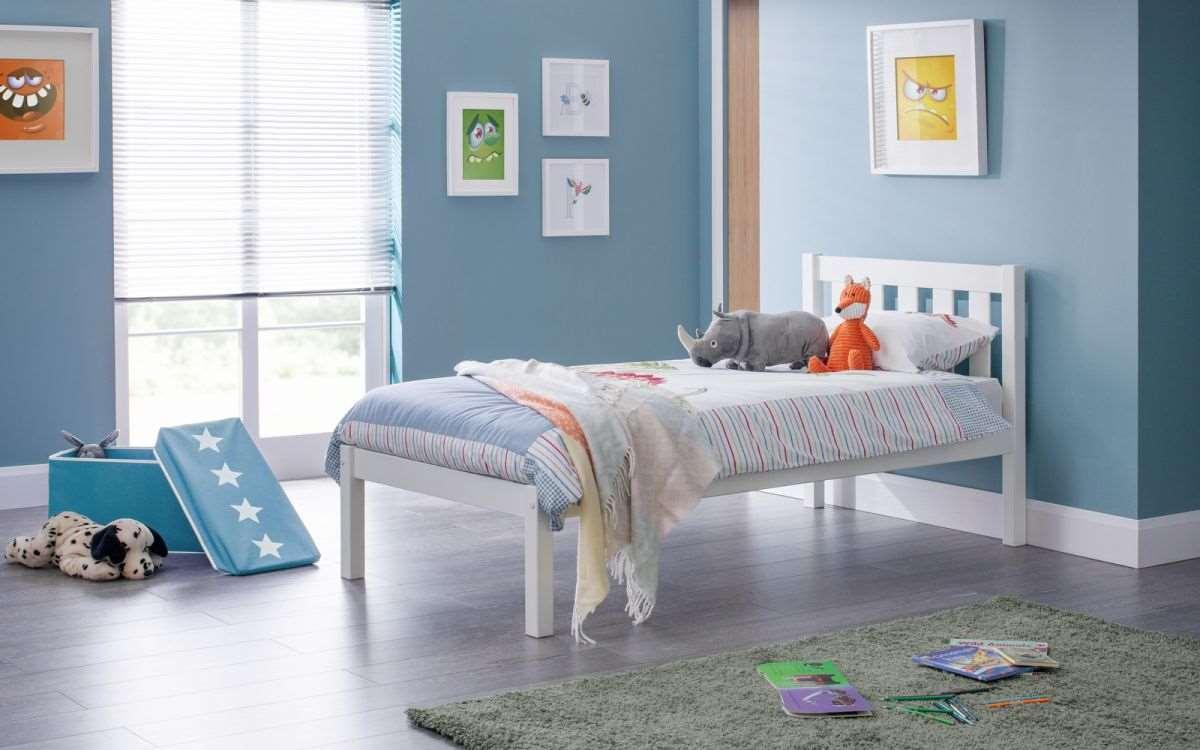 Luna Wooden Bed Frame in white in a modern bedroom with toys and framed art.