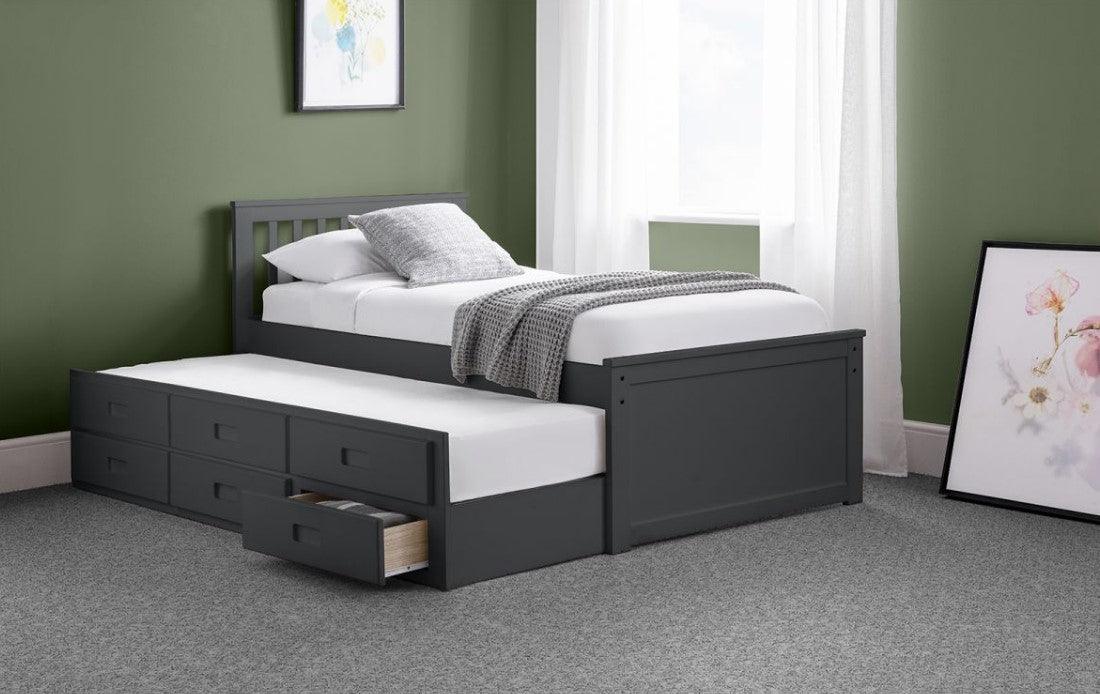 Wooden bed with pull-out underbed and storage drawers in a white lacquer finish.