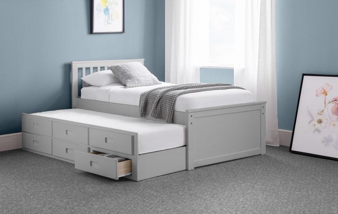 White wooden storage bed frame with pull-out underbed and drawers.