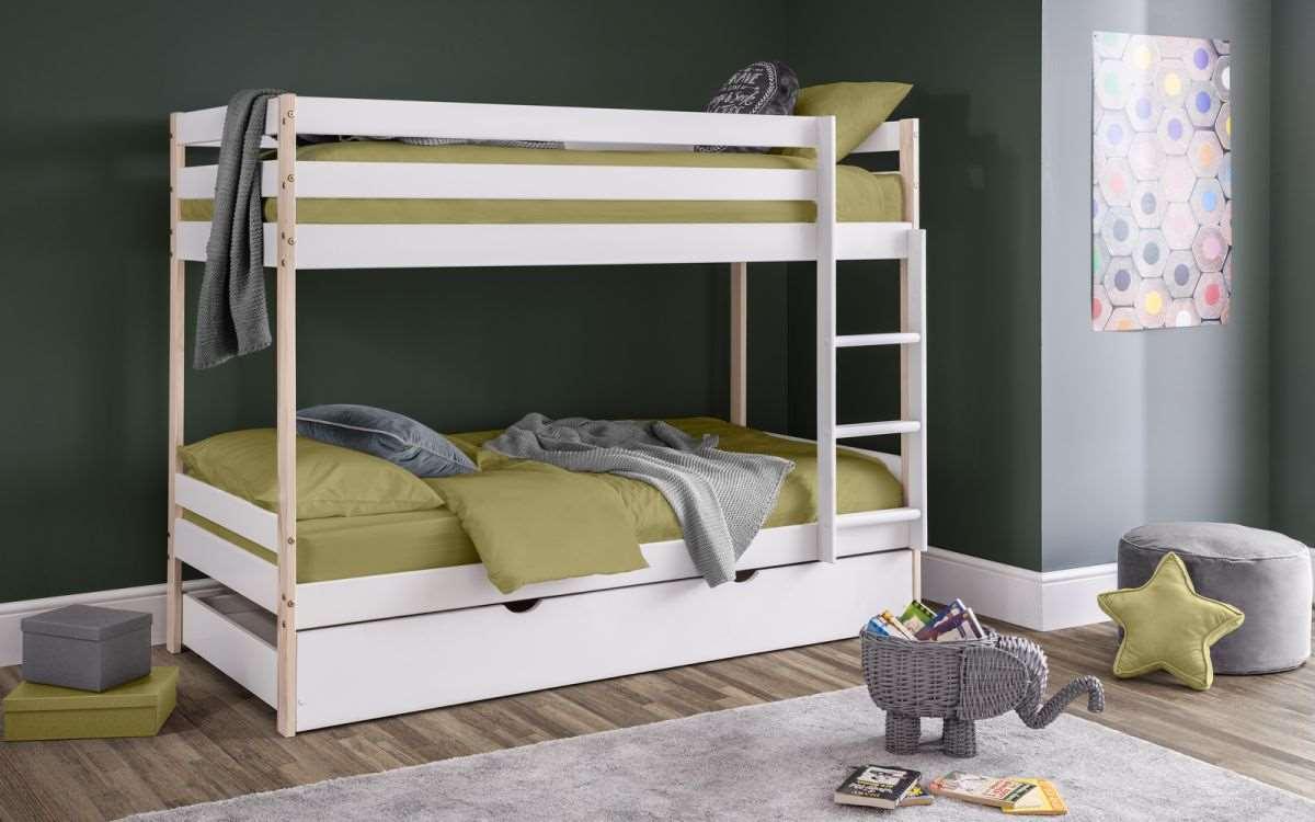 Nova Wooden Bunk Bed with Trundle in white and pine finish in a child's bedroom.